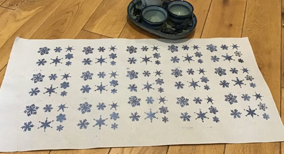 Gift wrapping paper with stencil snowflakes