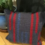 woolen cushion made by crocheting on fabric with wool