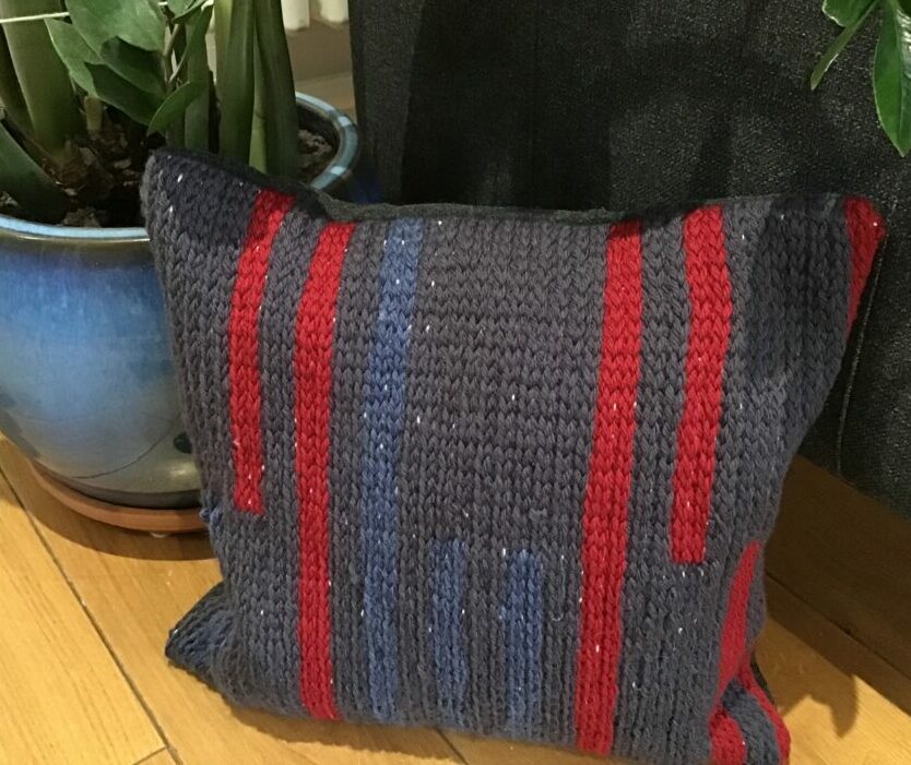 woolen cushion made by crocheting on fabric with wool