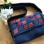 Bag with embroidery made out of wool fabric, old jeans and an upcycled shirt.