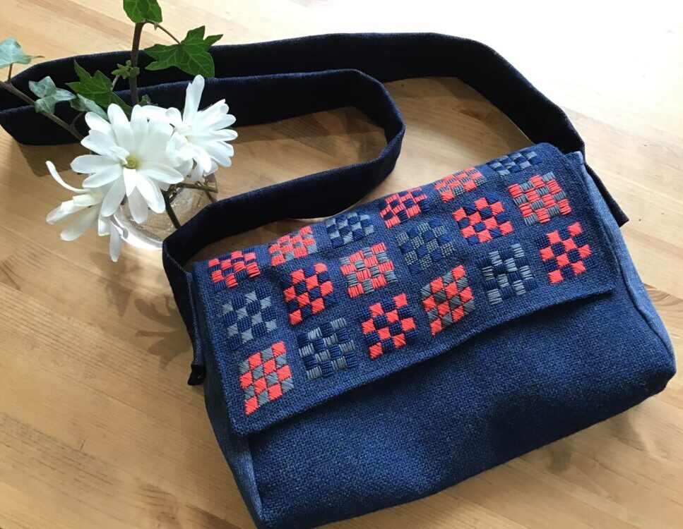 Bag with embroidery made out of wool fabric, old jeans and an upcycled shirt.