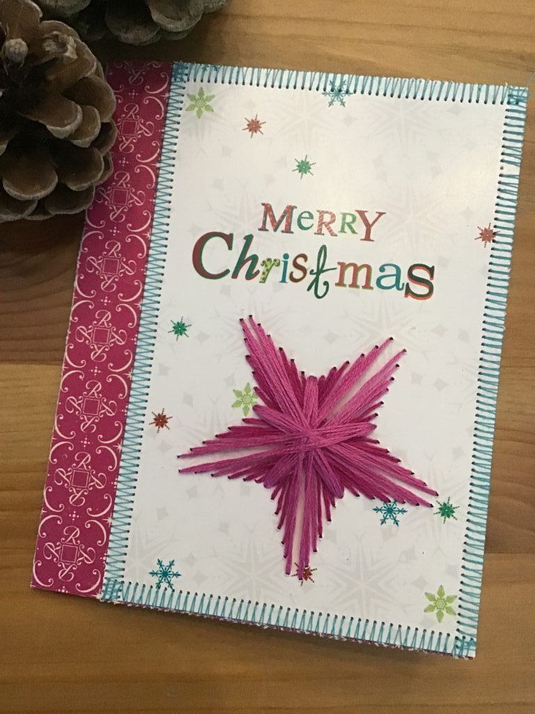 Broderet stjerne giver nyt liv til et gammelt julekort